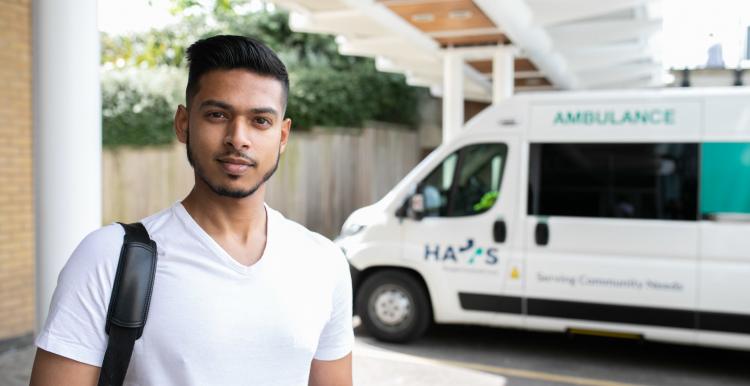 Man standing infront of an ambulance