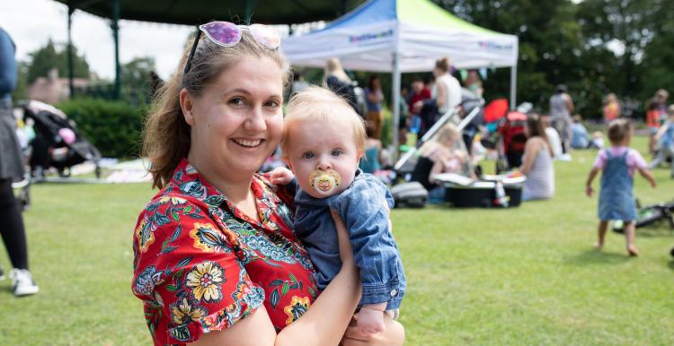 Mother holding baby at community event