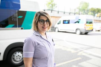 A nurse standing outside a hospital