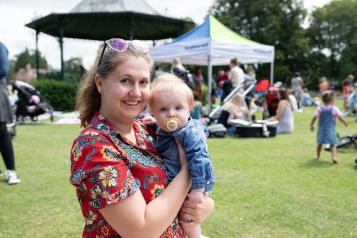 Mother holding baby at community event