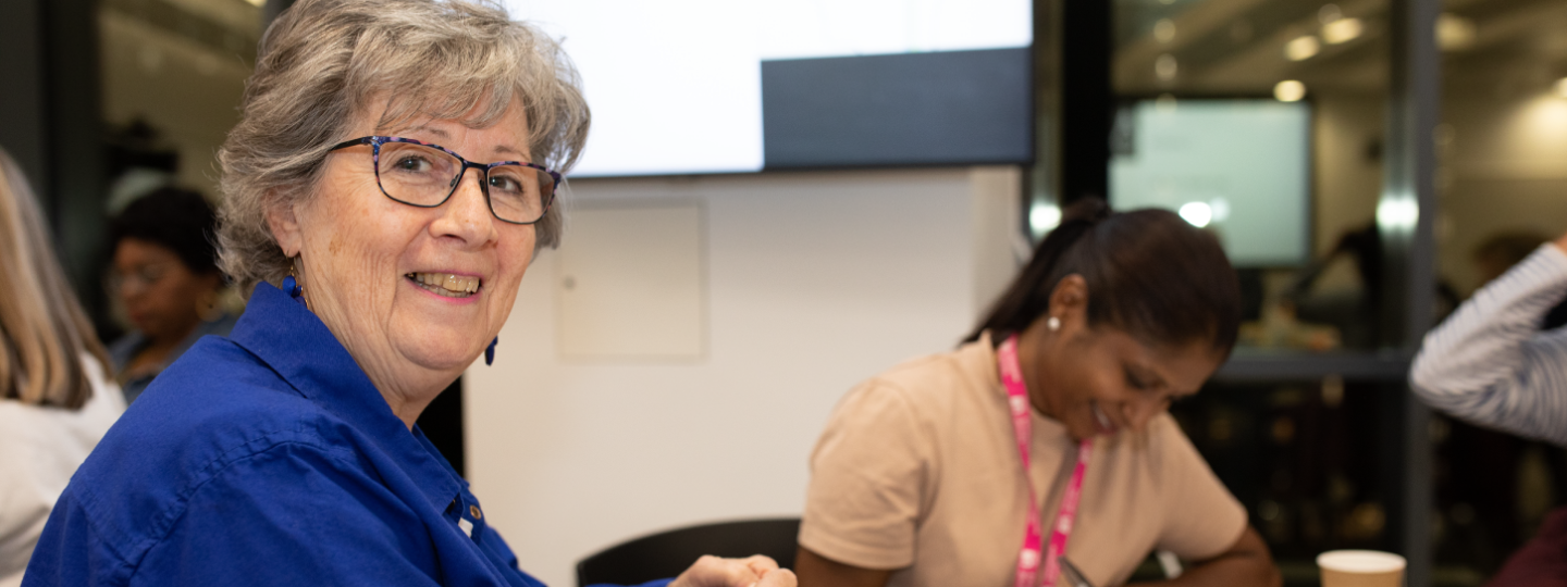 Lady with glasses looking at camera