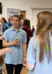 Group of young girls stood in a circle chatting 