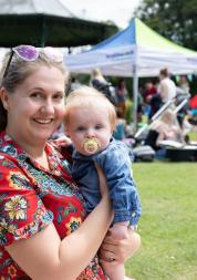 Mother holding baby at community event